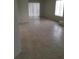 Bright living room featuring a sliding door, tile flooring, and neutral walls at 1936 St Lawrence Dr, Las Vegas, NV 89108