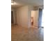Living room featuring tile flooring and access to bathroom and exterior doors at 1936 St Lawrence Dr, Las Vegas, NV 89108