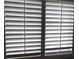 Close-up of a window with white wood shutters allowing natural light to filter through the slats at 1936 St Lawrence Dr, Las Vegas, NV 89108
