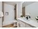 Modern bathroom featuring a tub with tile surround, matte black fixtures, and white marble countertops at 201 Kaelyn St # 4, Boulder City, NV 89005