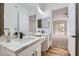 Bright bathroom features dual sinks, modern fixtures and view to the primary bedroom at 201 Kaelyn St # 4, Boulder City, NV 89005