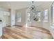 Bright dining area featuring hardwood floors, modern chandelier, and large windows with natural light at 201 Kaelyn St # 4, Boulder City, NV 89005
