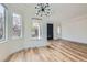 Open dining room featuring a modern light fixture, new windows and wood-look flooring at 201 Kaelyn St # 4, Boulder City, NV 89005