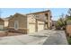 Two-story home with two-car garage and desert landscaping, showcasing a well-maintained facade at 201 Kaelyn St # 4, Boulder City, NV 89005