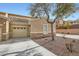 Charming single-Gathering house with stone accents, a two-car garage, and desert landscaping at 201 Kaelyn St # 4, Boulder City, NV 89005