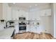 Bright kitchen with white cabinets, modern appliances, and countertops with a decorative backsplash at 201 Kaelyn St # 4, Boulder City, NV 89005