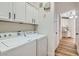 Efficient laundry room with white cabinets for storage, washer, and dryer at 201 Kaelyn St # 4, Boulder City, NV 89005