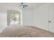 Spacious main bedroom with plush carpet, tray ceiling, and a sliding glass door to the backyard at 201 Kaelyn St # 4, Boulder City, NV 89005