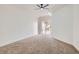 Bright main bedroom with carpet, ceiling fan, and sliding glass doors to the backyard at 201 Kaelyn St # 4, Boulder City, NV 89005