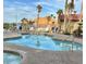 Resort-style community pool with comfortable lounge chairs and serene palm tree views at 201 Kaelyn St # 4, Boulder City, NV 89005