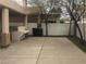 Spacious backyard area featuring a concrete patio, built-in seating, and mature trees at 206 Valerian St, Henderson, NV 89015