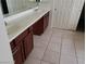 Bathroom features dual sinks, tile floor, and dark wood cabinets at 206 Valerian St, Henderson, NV 89015