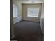 Bright bedroom with two windows and neutral carpeting at 206 Valerian St, Henderson, NV 89015