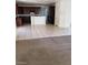 Open concept kitchen with dark wood cabinets and a large island with tile flooring at 206 Valerian St, Henderson, NV 89015