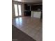 Open-concept living space with a tiled floor, bright kitchen, and patio access at 206 Valerian St, Henderson, NV 89015