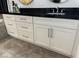 Bathroom vanity featuring a black countertop, stainless fixtures, and white cabinets at 2221 S Tioga Way, Las Vegas, NV 89117