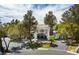 Stately home with lush landscaping and a circular driveway at 2221 S Tioga Way, Las Vegas, NV 89117