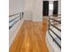 Upstairs hallway featuring hardwood floors and railing, showcasing access to other rooms at 2221 S Tioga Way, Las Vegas, NV 89117
