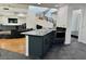 Gourmet kitchen with dark cabinets, stainless steel appliances, and an adjacent breakfast bar at 2221 S Tioga Way, Las Vegas, NV 89117