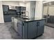 Modern kitchen island with stainless steel appliances and dark cabinets at 2221 S Tioga Way, Las Vegas, NV 89117