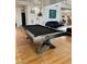 Living Room featuring a sleek pool table and hardwood flooring throughout at 2221 S Tioga Way, Las Vegas, NV 89117