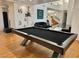 Spacious living room with unique pool table and view of spiral staircase at 2221 S Tioga Way, Las Vegas, NV 89117