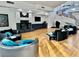 Bright living room with hardwood flooring, a fireplace, and a spiral staircase at 2221 S Tioga Way, Las Vegas, NV 89117