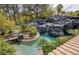 Beautiful pool area with bridge and rock waterfall at 2221 S Tioga Way, Las Vegas, NV 89117