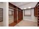 Spacious walk-in closet with custom wood shelving and ample storage space at 2221 S Tioga Way, Las Vegas, NV 89117