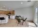 Open dining area features a stylish table set, adjacent to the kitchen with modern cabinetry and appliances at 2255 Bildad Dr, Henderson, NV 89044