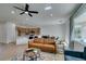 Bright living room with a modern ceiling fan, stylish furniture, and views to the outdoor space at 2255 Bildad Dr, Henderson, NV 89044