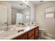 Bathroom with double vanity sinks, large mirror, and tiled floor at 2305 Dalton Ridge Ct, North Las Vegas, NV 89031