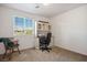 Bedroom has a desk with chair and wooden decorative chair at 2305 Dalton Ridge Ct, North Las Vegas, NV 89031