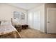 This bedroom is well-lit and features carpeted floors, a side table and a large window for natural light at 2305 Dalton Ridge Ct, North Las Vegas, NV 89031