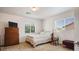 This bedroom is well-lit and features carpeted floors and a large window for natural light at 2305 Dalton Ridge Ct, North Las Vegas, NV 89031