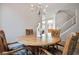 Close up of dining room showcasing a chandelier, wood table, and four decorative chairs at 2305 Dalton Ridge Ct, North Las Vegas, NV 89031