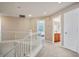 Upstairs hallway with white railings and neutral-colored walls at 2305 Dalton Ridge Ct, North Las Vegas, NV 89031