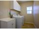 Laundry room features a washer, a dryer, and storage cabinets at 2305 Dalton Ridge Ct, North Las Vegas, NV 89031