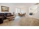 Spacious living room featuring carpet flooring, a chandelier, and a staircase at 2305 Dalton Ridge Ct, North Las Vegas, NV 89031