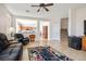 Open-concept living room showcasing tile floors, comfortable seating and connections to the kitchen at 2305 Dalton Ridge Ct, North Las Vegas, NV 89031