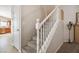 Carpeted stairs with a white handrail and views of the kitchen at 2305 Dalton Ridge Ct, North Las Vegas, NV 89031