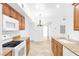 Bright kitchen with granite countertops, white appliances, and wood cabinets at 2615 W Gary Ave # 1041, Las Vegas, NV 89123