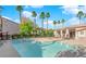 Large pool area surrounded by palm trees and lounge chairs at 2615 W Gary Ave # 1041, Las Vegas, NV 89123