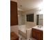 A bathroom with a combined bathtub and shower, single sink vanity and mirrored medicine cabinet at 2720 Knightsbridge Rd, Henderson, NV 89074