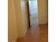 Hallway featuring neutral walls and wood-look floors, leading to various rooms in the home at 2720 Knightsbridge Rd, Henderson, NV 89074