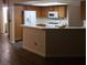 Kitchen with stainless steel appliances, wood cabinetry, and a breakfast bar at 2720 Knightsbridge Rd, Henderson, NV 89074