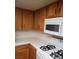 Kitchen with oak cabinets, white tile countertops, and modern white appliances at 2720 Knightsbridge Rd, Henderson, NV 89074