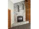 Elegant stone fireplace design, set against a log wall, adding warmth and rustic charm at 311 Crestview Dr, Las Vegas, NV 89124