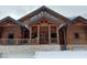 Stunning log cabin with a stone base, covered entryway and large windows at 311 Crestview Dr, Las Vegas, NV 89124