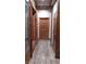 Hallway with natural wood trim, log accents, and modern flooring at 311 Crestview Dr, Las Vegas, NV 89124